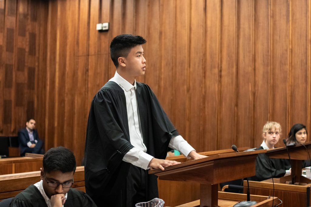 One of the Charter Challenge finalists and a member of the Richmond Hill High School team presents their argument in front of the panel of judges.